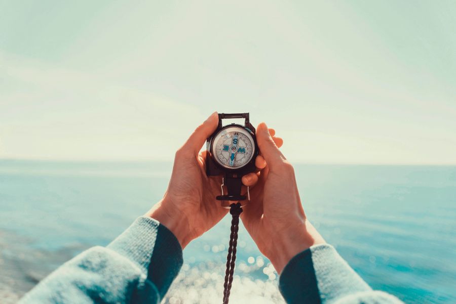 A compass is held with both hands